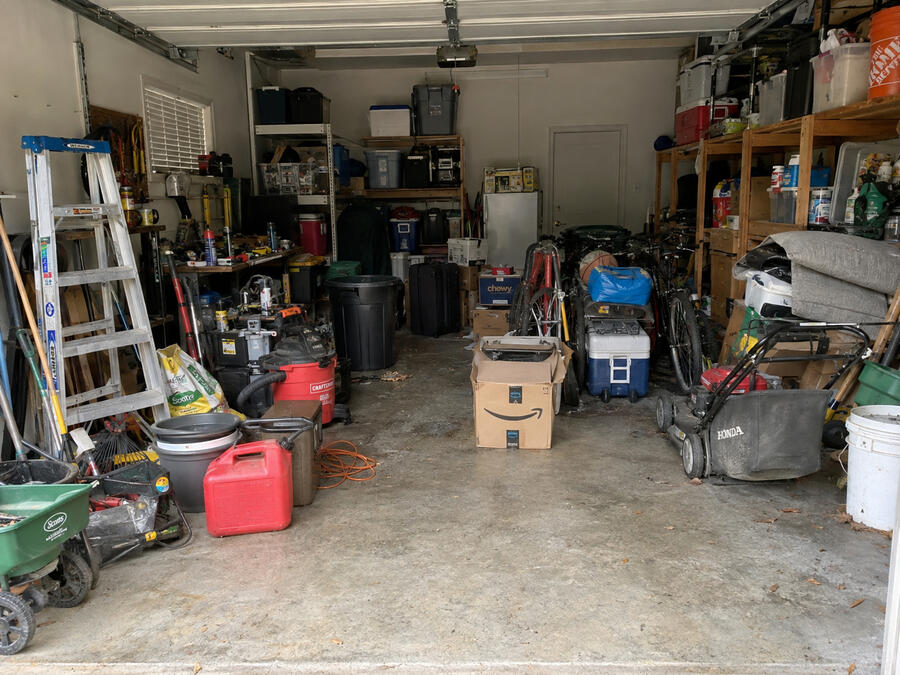 Cluttered garage before cleanout
